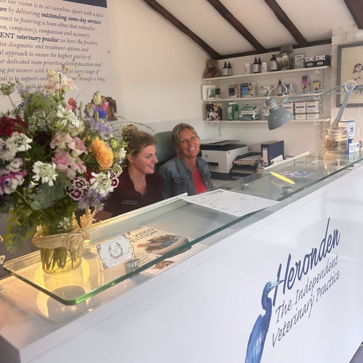 Charlie from reception and Jess, one of the vets, smiling together at Heronden Independent Veterinary Practice